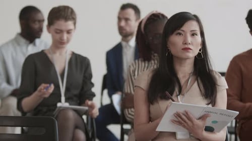 Asian Businesswoman Taking Notes on Conference
