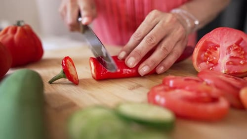 Adult Cutting Red Pepper on Cutting Board