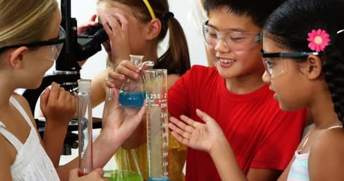 Children Doing Science Experiment in Classroom