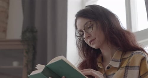Girl Reading A Book Dreamily Close Up