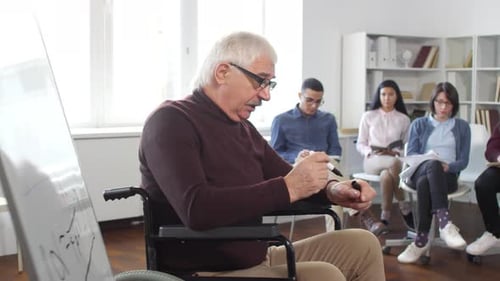 Man in Wheelchair Leading a Group Discussion