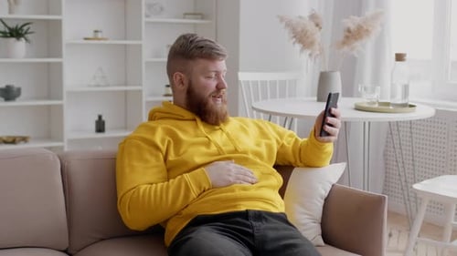 Man Chatting via Video Call on Couch