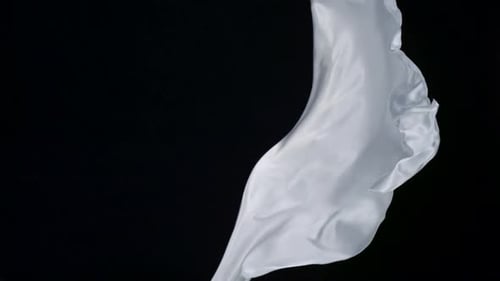 White Fabric Flowing on Black Background