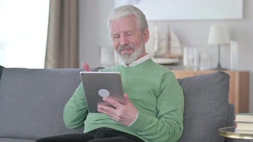 Senior Man Using Tablet for Video Call
