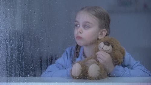 Pensive Child with Teddy Bear in Rainy Window