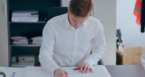 Businessman Working on a Project at Desk in Office