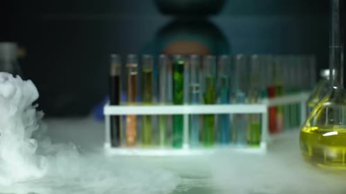 Chemist Opening Refrigerator and Taking Green Transparent Liquid Sample, Lotion
