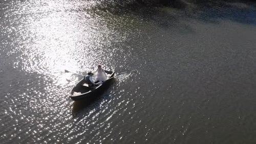 Wedding Couple Rowing Boat on River