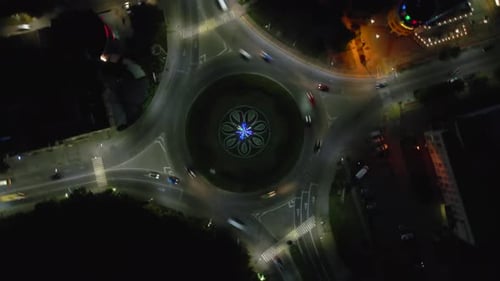 Aerial View Timelapse of Roundabout Road with Circular Cars at Night in Small European City