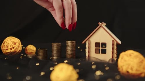 Crop Anonymous Female Collecting Coins in Pile for Real Estate Investment and Saving Money for