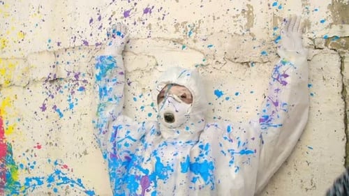 Person in Suit Covered in Paint Being Painted