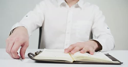 Opening an agenda and writing on it