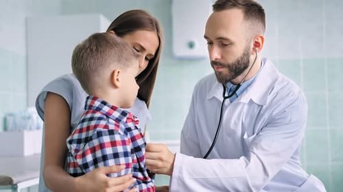 Doctor Examines Young Boy with Stethoscope