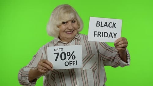 Grandmother Showing Black Friday and Up To 70 Percent Off Shopping Price Discount Advertisement