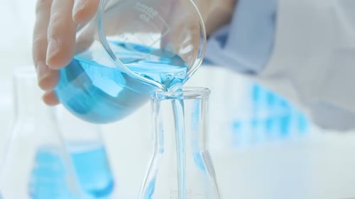 Pouring Chemical In Lab