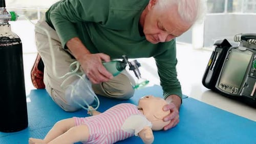 Adult Practices Infant CPR on Baby Doll