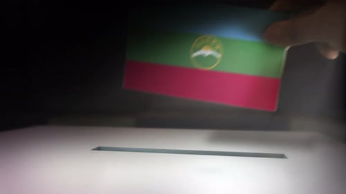 Hand Casting Flag Ballot into a Voting Box