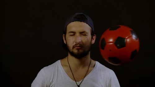 Young Adult Male Hit in Face with Soccer Ball