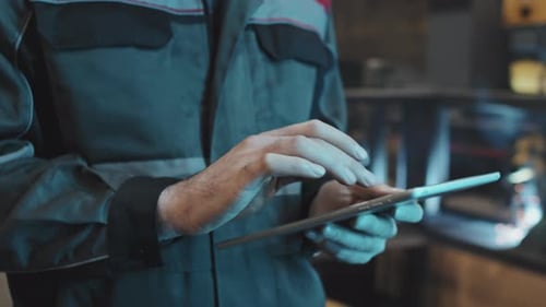 Man Using Tablet at Factory