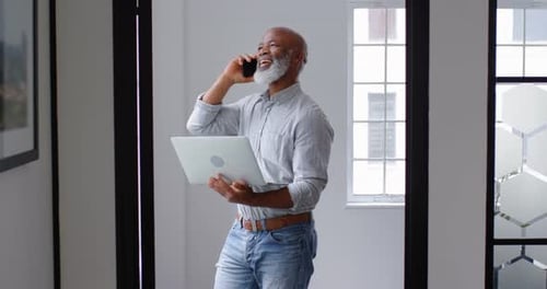 Adult Uses Laptop and Phone in Modern Workplace