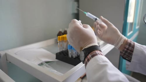Medical Worker Preparing Needle in Lab