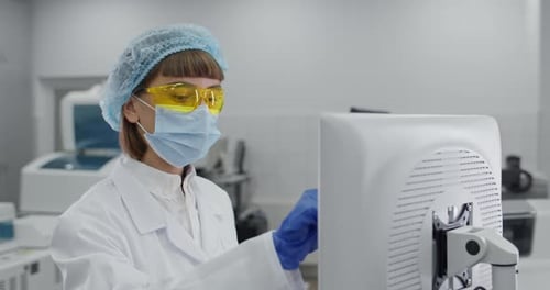 Medical Worker Using Computer in Clean Lab Environment