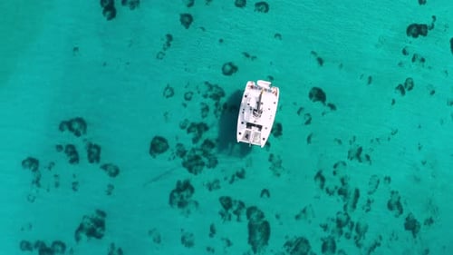 Aerial View of a Catamaran Yacht in the Blue Sea