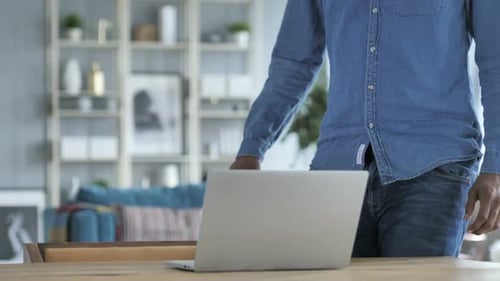 Young Adult Working on Laptop at Home