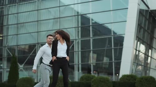 Young Couple In Business Suits Dancing Near Office Building