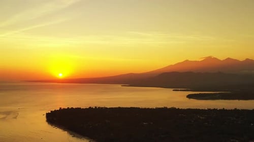 Wide angle drone travel shot of a sunshine white sandy paradise beach and aqua blue ocean background