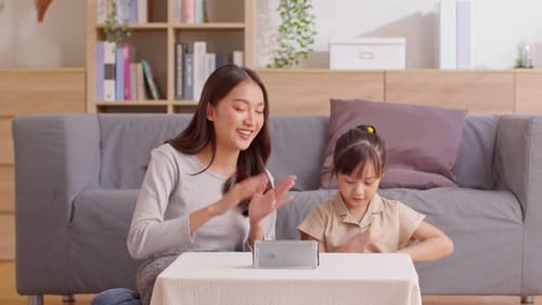 Smiling Woman and Child Enjoying Music at Home