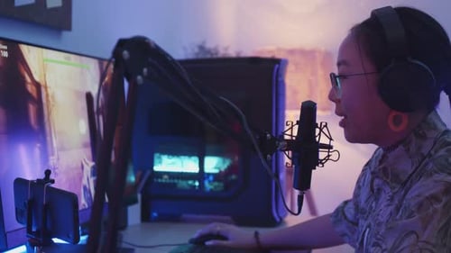 Young Adult Playing Computer Game at Night