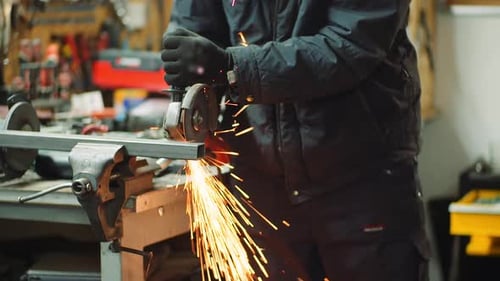 Angle Grinder Cutting Metal at Workshop