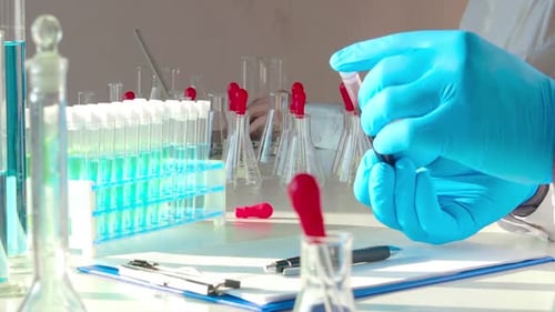 Close Up Footage - Doctor Holds a Test Tube with a Blood Sample.