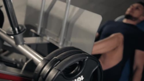 Man Using A Press Machine In A Fitness Club