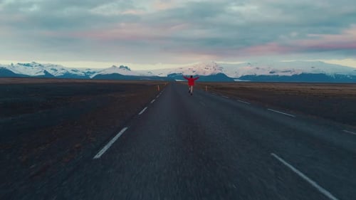 Man in red running on empty road