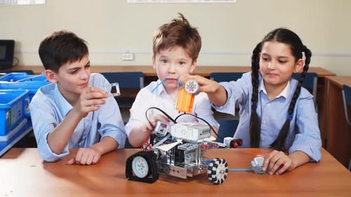 Children Building Robot Together in Classroom