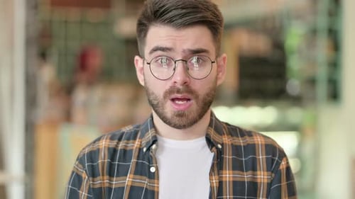 Angry Man Yelling with Arms Raised