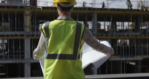 Female engineer looking at blueprint
