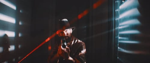 Man Aims Gun with Laser in Dark Environment