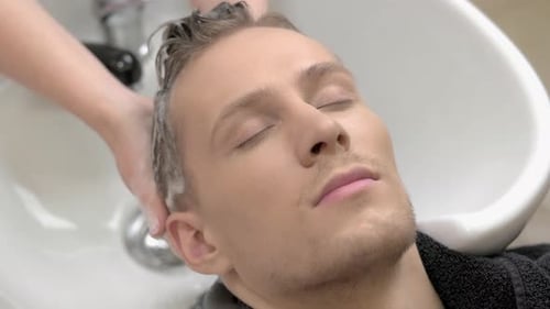 Man Having Hair Washed at Hair Salon