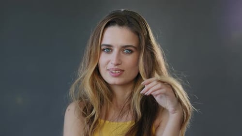Woman Posing with Long Wavy Hair in Studio