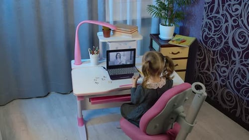 Child Attends Online Class at Home on Laptop