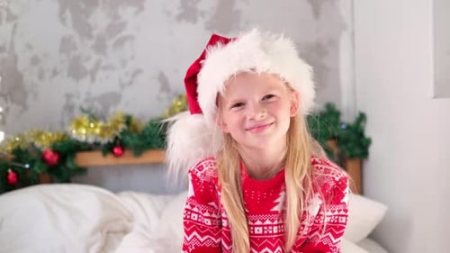 Happy Girl in Santa Hat on Christmas Morning