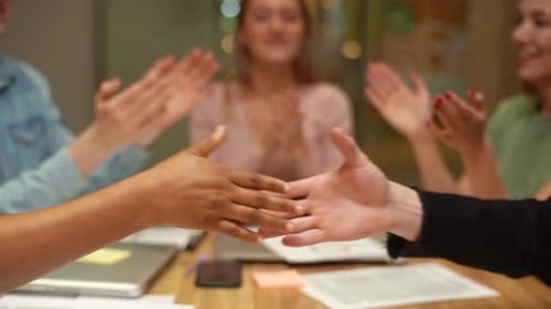Business Handshake During Applause in Office Meeting