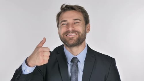 Man in Suit Gives Thumbs Up on White