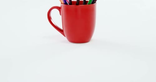 Colored pencils kept in red mug