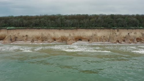 Aerial View of Sea Waves Beating Against a Rocky Shore on a Sandy Tropical Beach