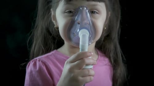 Child Using Nebulizer with Mask for Treatment
