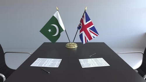 Pakistan and United Kingdom Flags on Conference Table